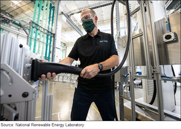 A researcher at the National Renewable Energy Laboratory tests the fit on a proof-of-concept megawatt-scale connector